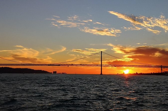 The bridge low on the horizon as the sun sets over the estuary