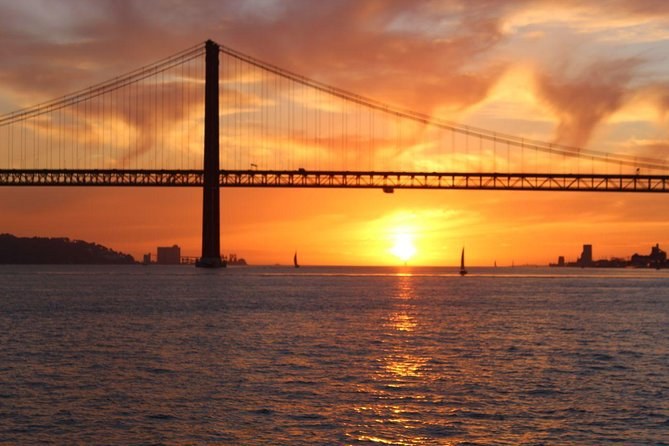 The suspension bridge over the Tagus at sunset, seen from the water