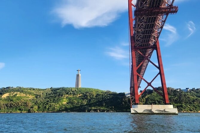 A red bridge pier and the Christ statue above the green south bank